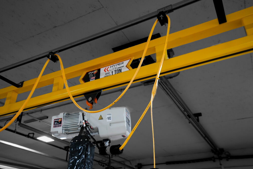 1 ton pwi freestanding hyperlite crane starke hoist with anver lifter in manufacturing setting 11