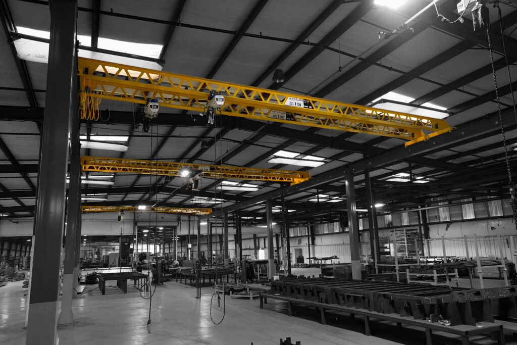 four 1 ton pwi freestanding ultralite bridges in trailer manufacturing setting