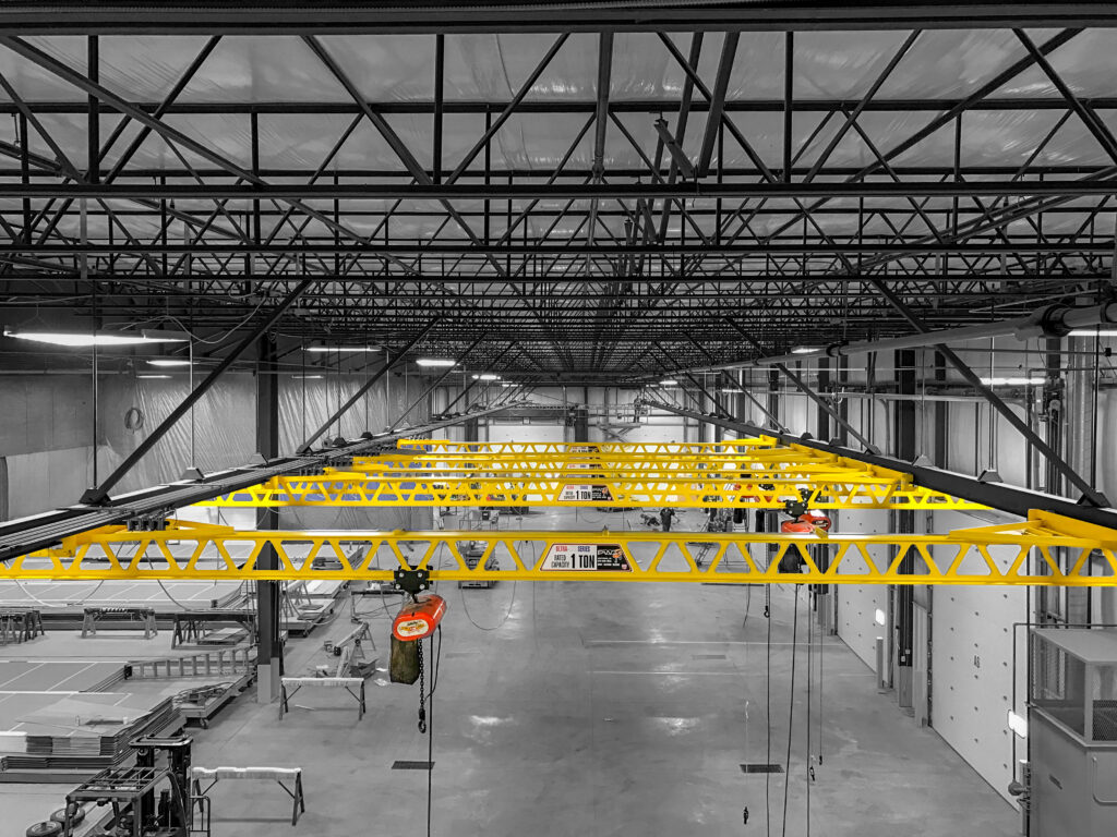 multiple 1 ton pwi ceiling mounted ultra lite cranes cm lodestar hoists in manufacturing setting 1