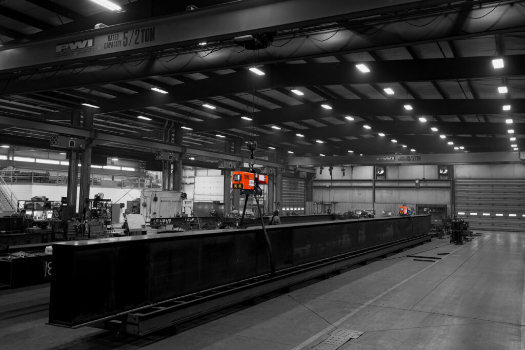 pwi torquewp rotation device lifting and rotating steel beam in manufacturing setting