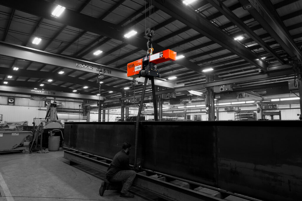 pwi torquewp rotation device lifting and rotating steel beam in manufacturing setting